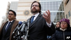 Justin Cox of the National Immigration Law Center, representing all the plaintiffs, right, with Omar Jadwat of ACLU, speaks to reporters outside the courthouse in Greenbelt, Maryland, March 15, 2017.