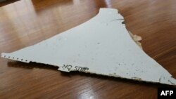 This file photo taken on March 3, 2016 shows a piece of suspected aircraft wreckage found off the east African coast of Mozambique at Mozambique's Civil Aviation Institute (IACM) in Maputo.