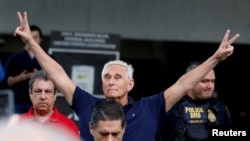 FILE - Long-time friend of President Donald Trump Roger Stone flashes victory signs after his appearance at Federal Court in Fort Lauderdale, Florida, Jan. 25, 2019.