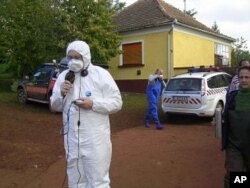 A VOA reporter preparing to enter the disaster zone near Kolontar, Hungary