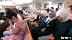 FILE - People from different faiths pray during an interfaith vigil for the victims of the Tennessee shooting, at Olivet Baptist church in Chattanooga, Tennessee, July 17, 2015. 