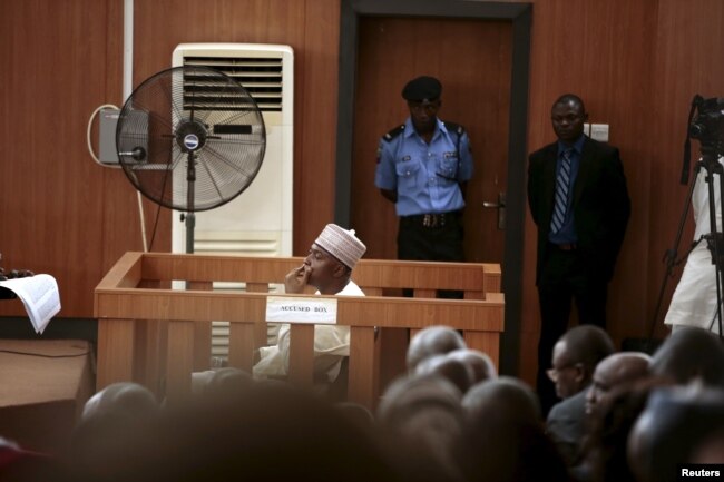 FILE - Nigeria's Senate President Bukola Saraki looks from the dock at the Code of Conduct Tribunal at Darki Biu, Jabi Abuja, Nigeria, Sept. 22, 2015.