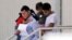 FILE - Immigrant families leave a United States Immigration and Customs Enforcement facility after they were reunited in San Antonio, July 11, 2018.