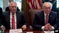 President Donald Trump, accompanied by Secretary of State Rex Tillerson, White House Senior Adviser Steve Bannon, left, and National Security Adviser H.R. McMaster, right, participates in a Cabinet meeting, June 12, 2017, in the Cabinet Room of the White 