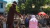 A religious officer canes an Acehnese youth onstage as punishment for dating outside marriage, which is against Sharia, or Islamic law on Aug. 1, 2016. The strictly Muslim province, Aceh is the only one in Indonesia with Sharia. 