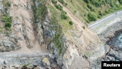 FILE - Landslides block State Highway One near Kaikoura on the upper east coast of New Zealand's South Island following an earthquake, Nov. 14, 2016.