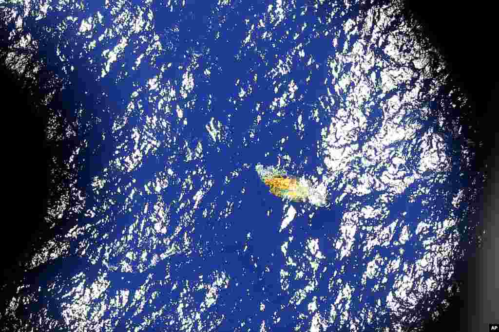 An image taken on board a Royal New Zealand P-3 Orion shows a piece of unknown debris floating just under the water while the plane was searching for missing Malaysia Airlines Flight MH370 in the southern Indian Ocean, Australia.