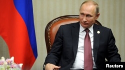 Russian President Vladimir Putin attends a meeting at the Asia-Pacific Economic Cooperation Summit in Lima, Peru, Nov. 19, 2016. In remarks made as part of a documentary film produced by American filmmaker Oliver Stone, Putin suggests Russia's annexation of Crimea from Ukraine was motivated by fear over the fate of Sevastopol, where Russia's Black Sea fleet is based. 