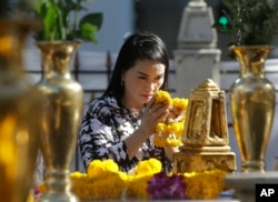 A woman prays at the Erawan Shrine at Rajprasong intersection the day after a deadly explosion in Bangkok, Thailand, Aug. 19, 2015.