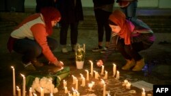 Warga meletakkan lilin untuk mengenang tiga orang mahasiswa muslim, korban penembakan di luar kampus Universitas North Carolina di Chapel Hill, North Carolina (11/2).