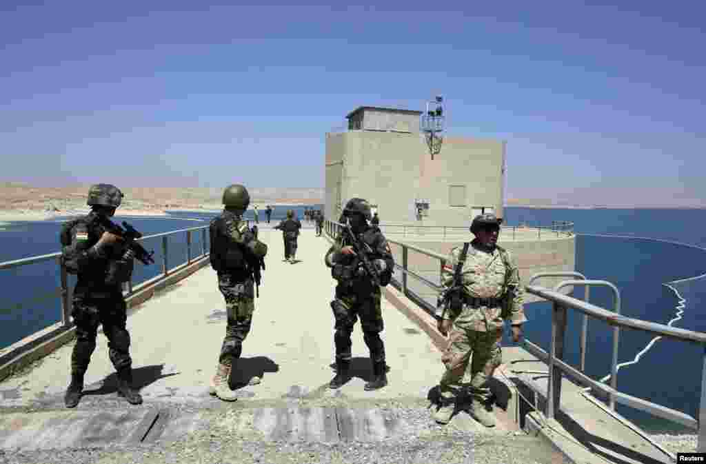 Peshmerga fighters stand guard at Mosul Dam, Aug. 21, 2014.