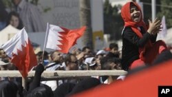 Bahraini anti-government protesters chant and wave Bahraini flags at the Pearl roundabout in Manama, Bahrain, Sunday, Feb. 20, 2011