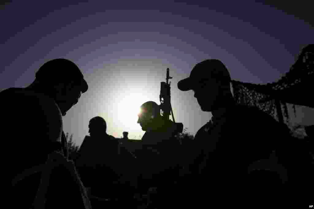 Pro-Russian gunmen guard a checkpoint outside Slovyansk, eastern Ukraine, May 15, 2014. 