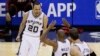 San Antonio Spurs guard Manu Ginobili (20), guard Patty Mills (8) and center Tiago Splitter (22) celebrate against the Miami Heat during the second half in Game 5 of the NBA basketball finals on Sunday, June 15, 2014.