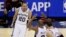 San Antonio Spurs guard Manu Ginobili (20), guard Patty Mills (8) and center Tiago Splitter (22) celebrate against the Miami Heat during the second half in Game 5 of the NBA basketball finals on Sunday, June 15, 2014.