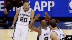 San Antonio Spurs guard Manu Ginobili (20), guard Patty Mills (8) and center Tiago Splitter (22) celebrate against the Miami Heat during the second half in Game 5 of the NBA basketball finals on Sunday, June 15, 2014.