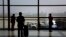 FILE - Passengers wait to board their plane at Shanghai's Hongqiao International Airport, April 16, 2012.