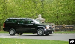 FILE - A motorcade SUV vehicle transporting President Donald Trump leaves the Trump National Golf Club in Bedminster, N.J., May 7, 2017.
