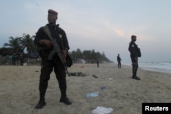 Soldiers stand in guard on the beach in Grand Bassam, Ivory Coast, after a terrorist attack on a resort there March 13, 2016.