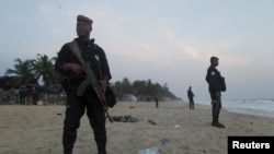 FILE - Soldiers stand in guard on the beach in Grand-Bassam, Ivory Coast, after a terrorist attack on a resort there March 13, 2016.
