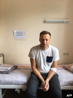 FILE - A handout image made available on the official website of Russia's opposition leader Alexei Navalny (Navalny.com) July 29, 2019, shows him sitting on a hospital bed in Moscow.