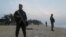 FILE - Soldiers stand in guard on the beach in Grand-Bassam, Ivory Coast, after a terrorist attack on a resort there March 13, 2016.