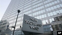 FILE - A view of New Scotland Yard, the headquarters building of the Metropolitan Police, with its sign in London, Dec. 20, 2010.