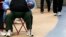 FILE - An overweight woman sits on a chair in Times Square in New York, May 8, 2012. In 2015, excess weight affected 2.2 billion people, equal to 30 percent of the world's population, according to a new study. 