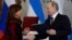 Russian President Vladimir Putin and Argentina's President Cristina Fernandez exchange documents at a signing ceremony in the Kremlin in Moscow, April 23, 2015.