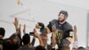 Vegas Golden Knights defenseman Shea Theodore gives his stick to fans after the Knights defeated the Washington Capitals 6-4 in Game 1 of the NHL hockey Stanley Cup Finals Monday, May 28, 2018, in Las Vegas.