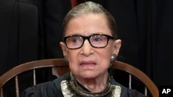 Associate Justice Ruth Bader Ginsburg sits with fellow Supreme Court justices for a group portrait at the Supreme Court Building in Washington, Nov. 30, 2018.