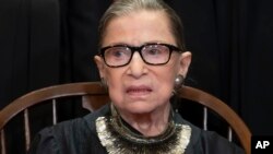 Associate Justice Ruth Bader Ginsburg sits with fellow Supreme Court justices for a group portrait at the Supreme Court Building in Washington, Nov. 30, 2018.