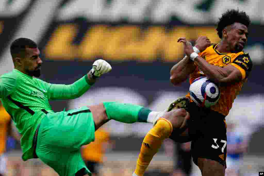 Wolverhampton Wanderers' Adama Traore is hit by Brighton's goalkeeper Robert Sanchez during the English Premier League soccer match between Wolverhampton Wanderers and Brighton &amp; Hove Albion at the Molineux Stadium in Wolverhampton, England.