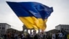 FILE - A woman waves a huge Ukrainian flag during rally to mark the 32nd anniversary of Ukraine's independence and to protest against the Russian war on Ukraine, in Berlin, Germany, Thursday, Aug. 24, 2023.