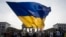 FILE - A woman waves a huge Ukrainian flag during rally to mark the 32nd anniversary of Ukraine's independence and to protest against the Russian war on Ukraine, in Berlin, Germany, Thursday, Aug. 24, 2023.