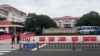 Police officers keep watch near an entrance to the Wuxi Vocational College of Arts and Technology following a knife attack in Wuxi, Jiangsu province, China, on Nov. 17, 2024.