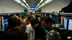 Des migrants bloqués à bord d'un train à Munich, en Allemagne à la gare Keleti à Budapest, Hongrie, le lundi 31 août 2015.