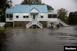 Water from the Neuse River closes in on a house as Hurricane Florence begins to make its destructive presence known in New Bern, N.C., Sept. 13, 2018.