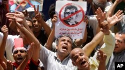 Egyptian protesters shout anti-Muslim Brotherhood slogans as they hold posters depicting U.S. Ambassador to Egypt Anne Patterson and President Mohammed Morsi during a protest in Tahrir Square in Cairo, Egypt, June 28, 2013.