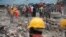 FILE - Rescue workers are seen on the site of a collapsed building in Lagos, Nigeria, Sept. 16, 2014.