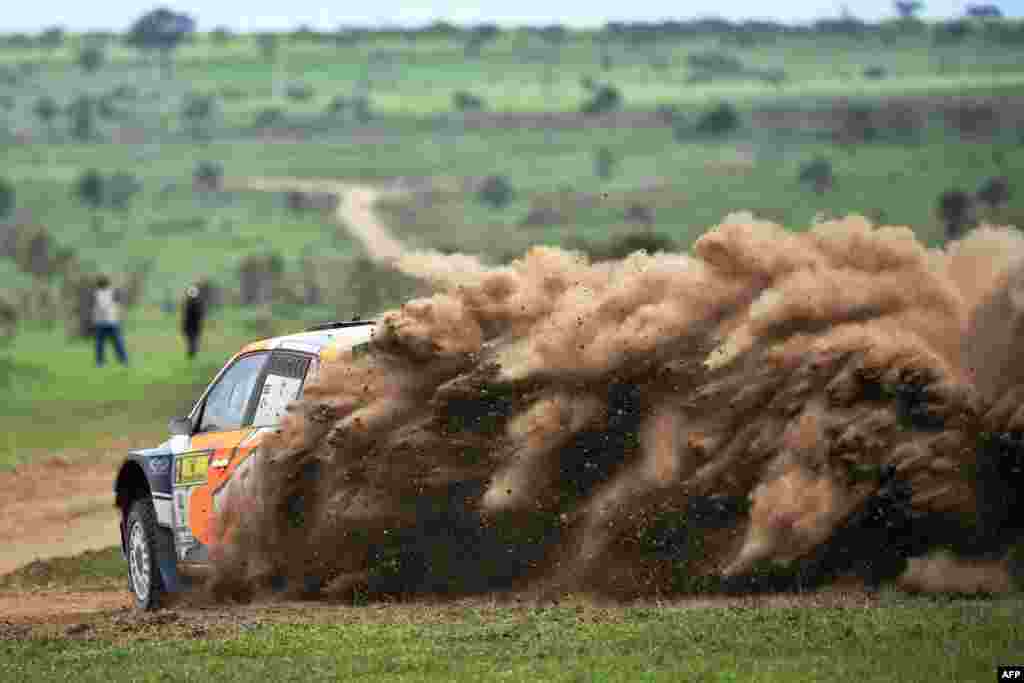 Kenya’s Manvir Baryan and his British navigator Drew Sturrock kick up a dust cloud in the Skoda Fabia R5 during the second day of the safari rally at Soysambu ranch near Kenya's lakeside town of Naivasha, July 6, 2019.