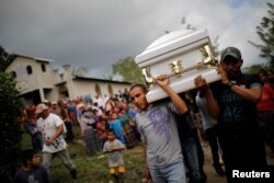 Friends and family carry a coffin with the remains of Jakelin Caal, 7, who died while in the custody of U.S. Customs and Border Protection, during her funeral at her home village of San Antonio Secortez, in Guatemala, Dec. 25, 2018.