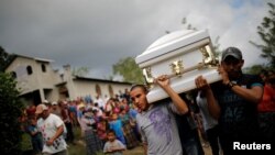 Friends and family carry a coffin with the remains of Jakelin Caal, 7, who died while in the custody of U.S. Customs and Border Protection, during her funeral at her home village of San Antonio Secortez, in Guatemala, Dec. 25, 2018.