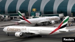 FILE - Emirates Airline Boeing 777-300ER planes are seen at Dubai International Airport in Dubai, United Arab Emirates, February 15, 2019. Several airlines canceled flights to the U.S or changed planes they were using because of concerns about the new 5G service. 