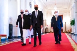 President Joe Biden walks to the Quad summit with, from left, Australian Prime Minister Scott Morrison, Indian Prime Minister Narendra Modi, and Japanese Prime Minister Yoshihide Suga, in the East Room of the White House, Sept. 24, 2021.