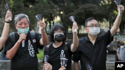 FILE - In this June 4, 2020, file photo, from left, pro-democracy activists Lee Cheuk-yan, Chow Hang Tung, and Cheung Man-kwong attend a gathering to mourn for those killed in the 1989 Tiananmen crackdown at Victoria Park, in Hong Kong.