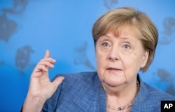 FILE - German Chancellor Angela Merkel speaks at a press conference following her visit to the Robert Koch Institute in Berlin, July 13, 2021.