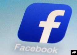 FILE - The Facebook app icon is seen on a smartphone in New York.
