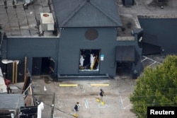 Federal Bureau of Investigation (FBI) officials collect evidence from the Pulse gay night club, the site of a mass shooting days earlier, in Orlando, Florida, U.S., June 15, 2016.