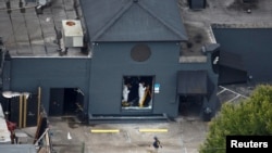 FILE - Federal Bureau of Investigation (FBI) officials collect evidence from the Pulse gay night club, the site of a mass shooting days earlier, in Orlando, Florida, U.S., June 15, 2016.
